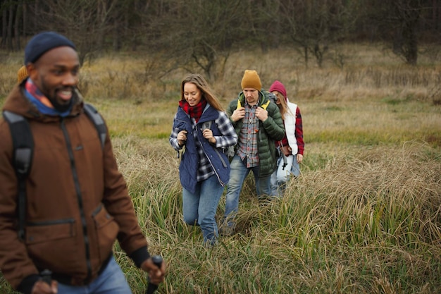 Group of friends on a camping or hiking trip in autumn day