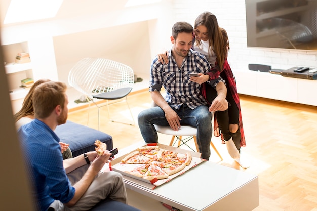 Group of friends eating pizza