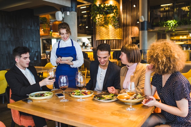 Group of friends eating in restaurant