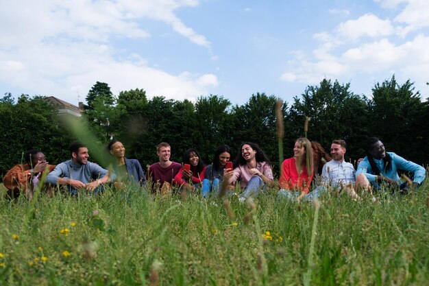 Group of friends from different cultures having a picnic in the park outdoors