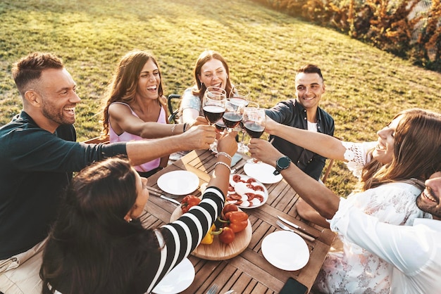 Group of friends having fun at bbq outside dinner in home garden