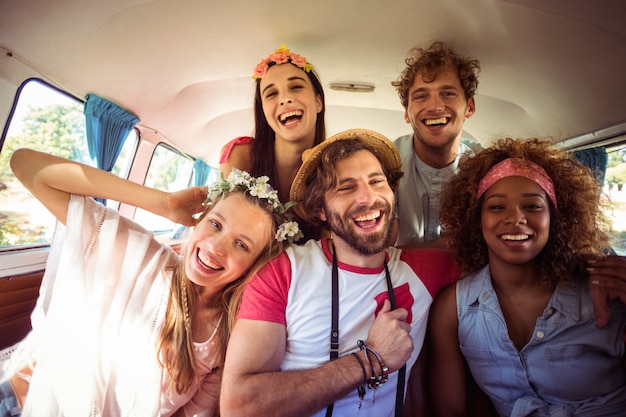 Group of friends having fun in campervan