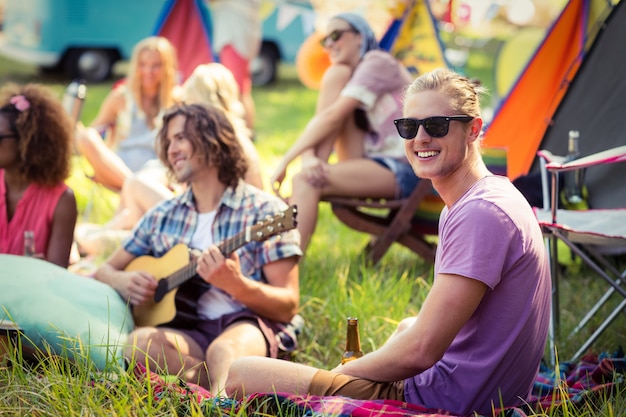 Group of friends having fun together at campsite