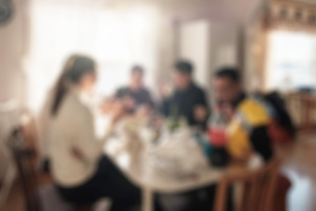 Group of friends having fun with eating food and talking on dining table at weekend