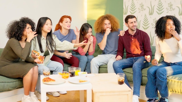 Group of friends at home watching a game on tv