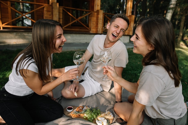 A group of friends on a picnic in the woods having fun