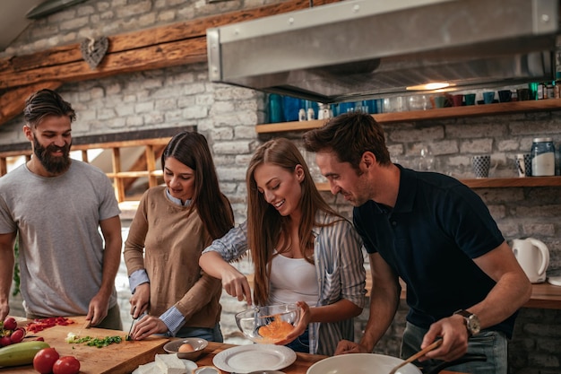 Group of friends preparing lunch in the kitchen