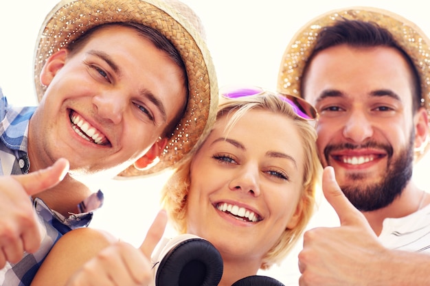 a group of friends showing ok signs to the camera