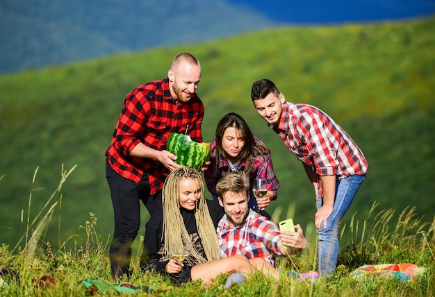 Group friends taking selfie Capturing memories Men and women posing for family photo Send selfie social networks Selfie time concept People in nature taking happy selfie landscape background