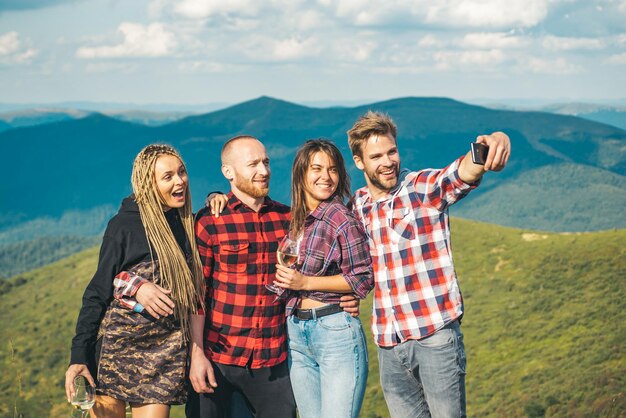 Group of friends taking a selfie in the mountains group of hikers takes photo in nature camping toge