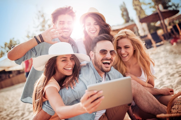 Group of friends taking selfie with smart phone