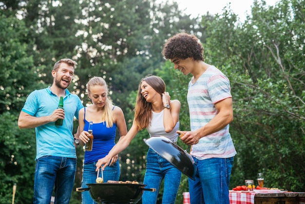 Group of friends toasting together and making barbecue