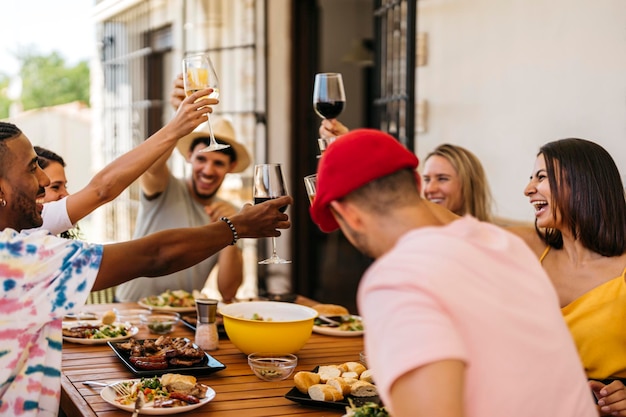 Group of friends toasting while eating a barbeque