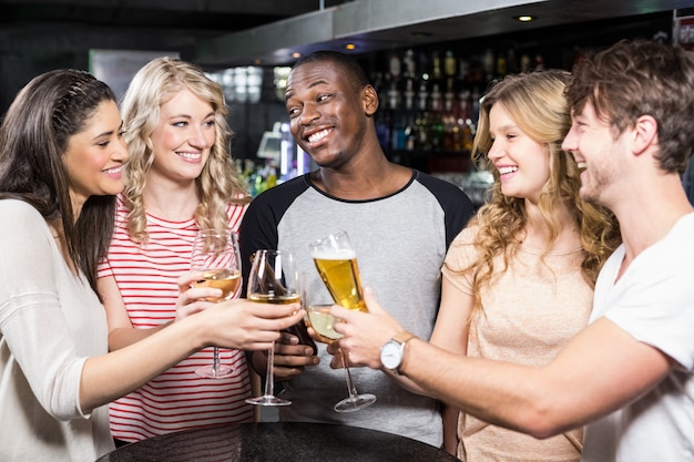 Group of friends toasting with beer and wine