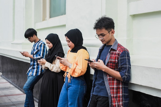 Group of friends using mobile smart phones