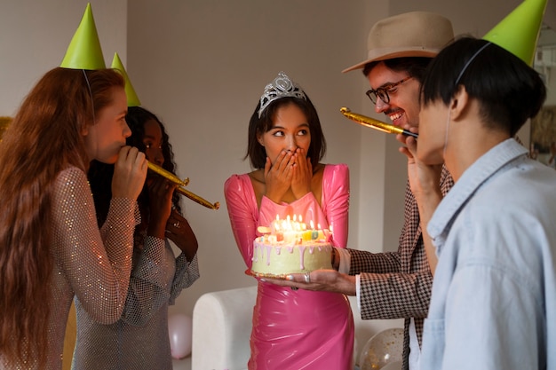 Group of friends with cake at a surprise birthday party