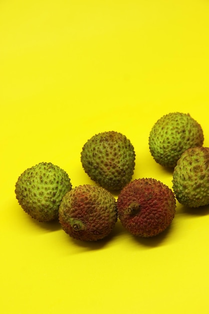 a group of fruits that are on a yellow background