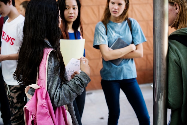 Group of girl students talking in a circle 