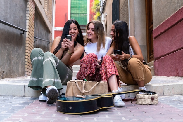 Group of girlfriends using their smartphones