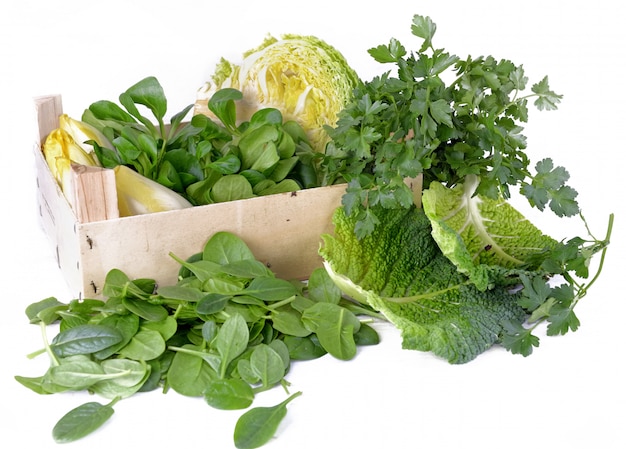 Group of green  leaf of spinack, parsley, cabbage and other fresh vegetables in  crate