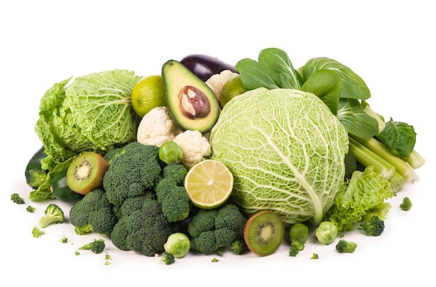 Group of green vegetables and fruits on white