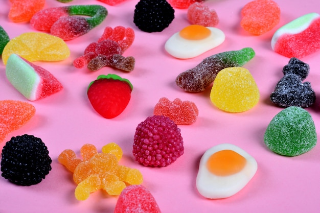 Group of gummy candies on pink background