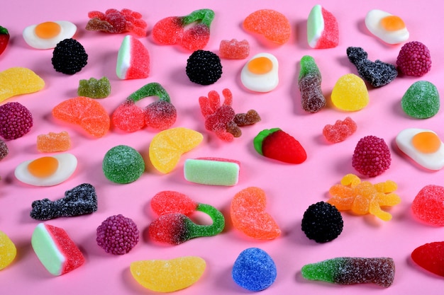 Group of gummy candies on pink 