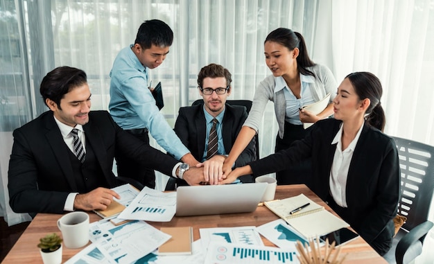 Group of happy businesspeople in celebratory gesture and successful efficient teamwork Diverse race office worker celebrate after made progress on marketing planning in corporate office Habiliment