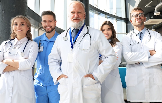 Group of happy doctors in hospital corridor, portrait.