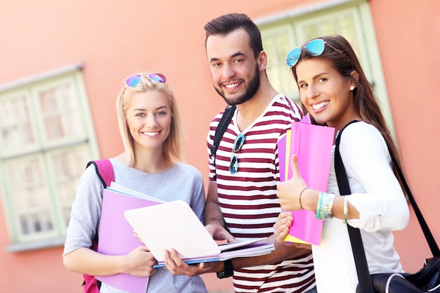 group of happy students studying outdoors