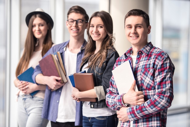 Group of happy young students in a university.