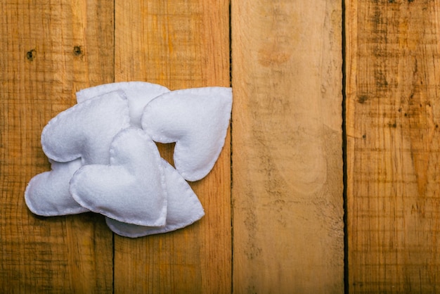 Group of hearts made of felt on wooden table  Valentines day background