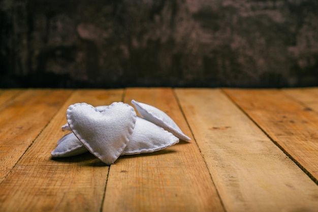 Group of hearts made of felt on wooden table  Valentines day background