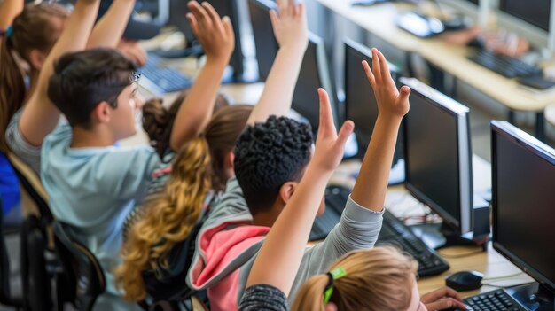 group of high school students hands up in computer class