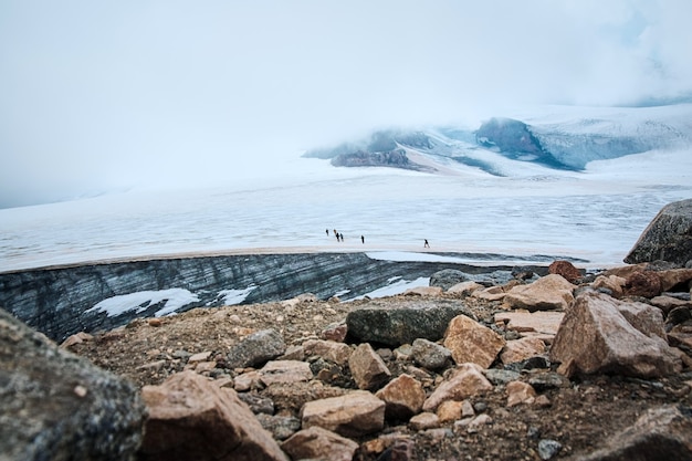 A group of hikers ascending a snowing mountain in sunny winter morning