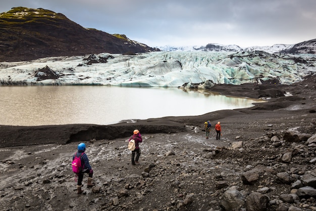 Group of hikers walking to glacier with guide