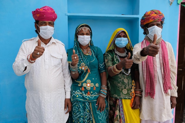 Group of Indian people in national costumes wearing face masks during the COVID-19 pandemic