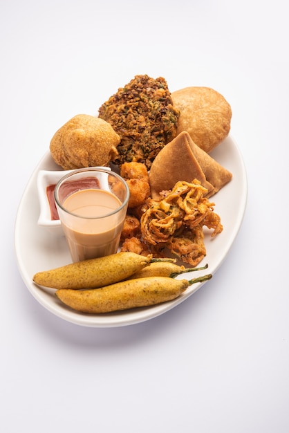 Group of Indian tea time snacks samosa, kachori, aloo bonda, onion pakora, moong vada, chilli fritter etc