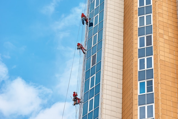 Group of industrial climber work on a modern building outdoor