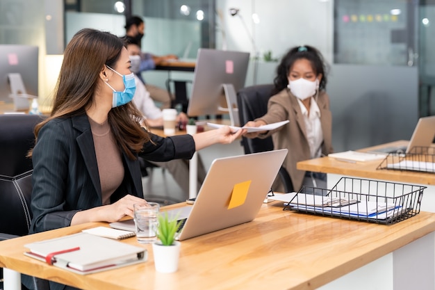 Group of interracial business worker team wear protective face mask in new normal office