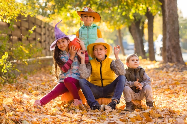 Group of little kids enjoying harvest festival celebration at pumpkin fields