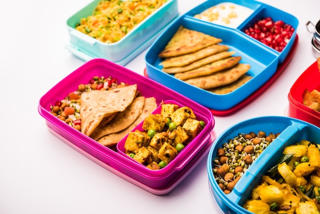 Group of Lunch Box or Tiffin for Indian kids, showing variety or multiple option or combination of healthy food for your school going children