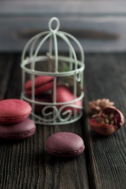 Group of macarons made of strawberries, cream, chocolate and blueberries. Rustic photo.