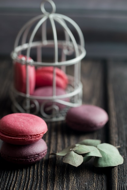 Group of macarons made of strawberries, cream, chocolate and blueberries. Rustic photo.