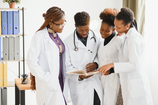 Group of medical doctors in office with patient's x-ray