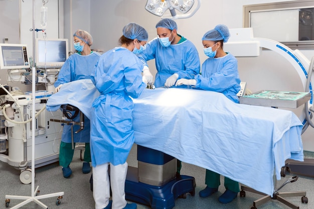 Group of medical team urgently doing surgical operation and helping patient in theater at hospital Medical team performing surgical operation in a bright modern operating room