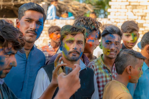 A group of men with colored powder on their faces