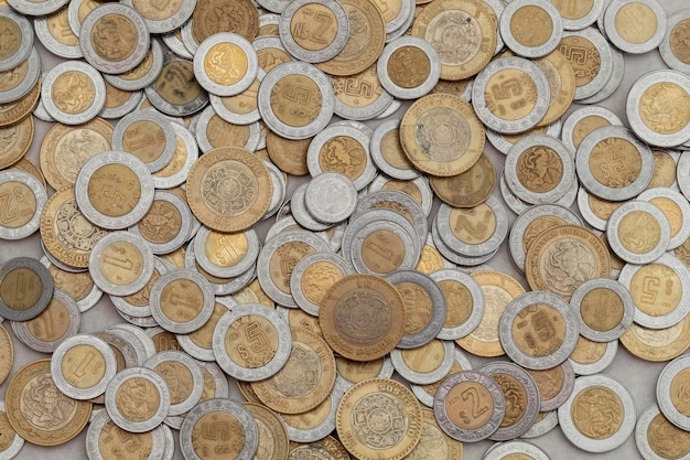 Group of mexican peso coins of various denominations with copy space