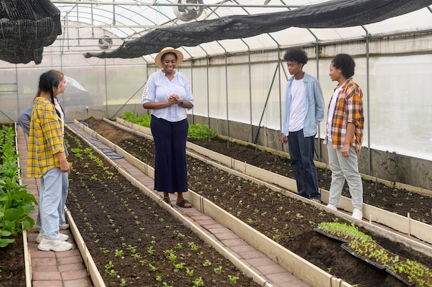 Group of mixed race students and teacher learning agriculture technology in smart farming