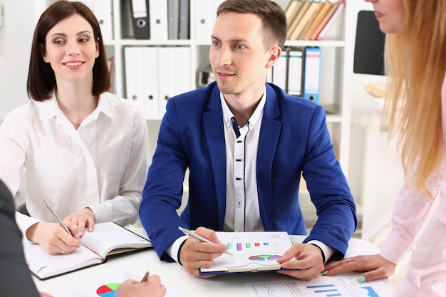 Group of modern business people working with financial chart